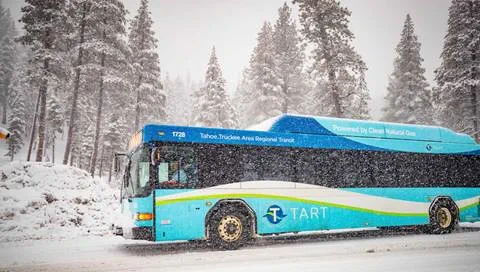 A TART bus drives to the mountain in snowy conditions.